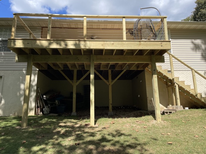 Second-story wood deck with stairs to the yard